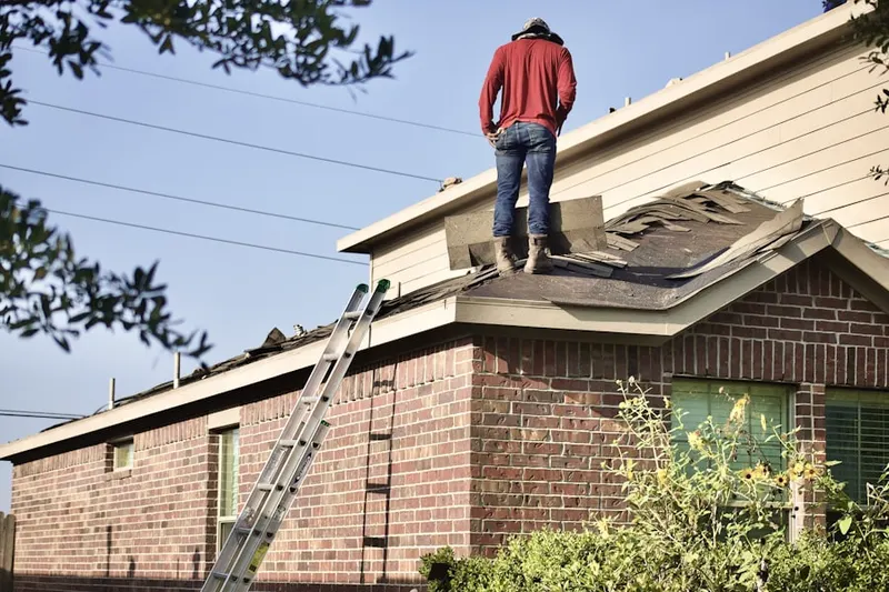 Professional roofer working on a residential roof in Trailridge